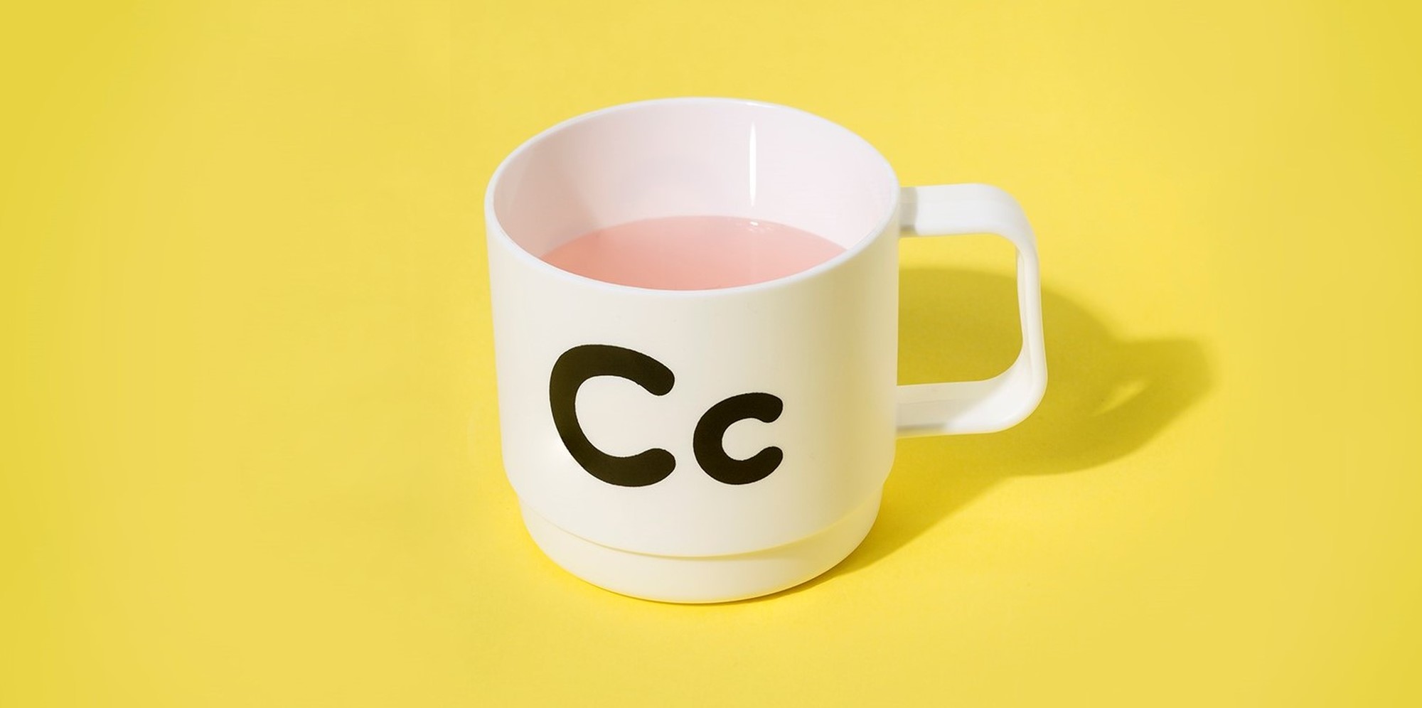 A white mug with black letters "Cc" on the side of it