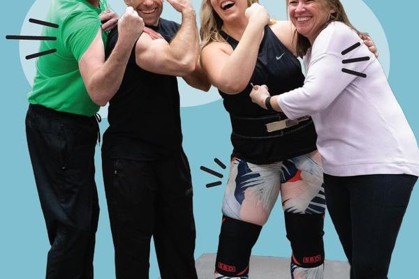 A group of people flexing their arms