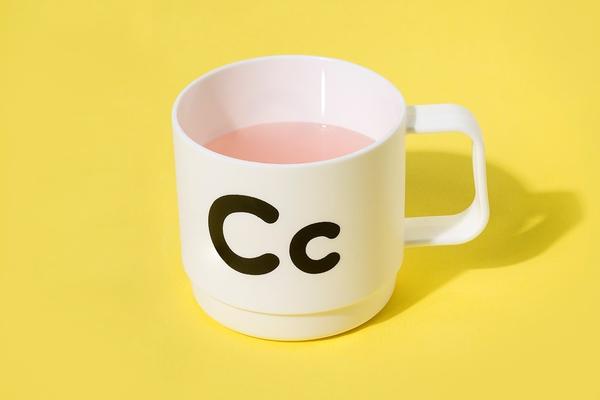 A white mug with black letters "Cc" on the side of it